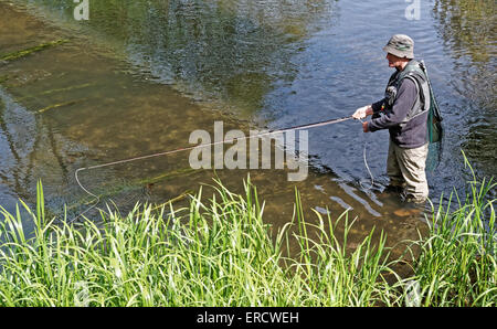Man fly-fishing in Wiltshire Stock Photo