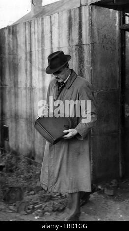 A Scotland Yard detective examining evidence at the murder scene of Amy