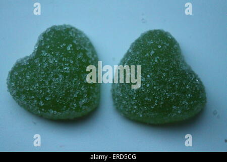 two sweet heart from green apple taste jelly covering shine crystals of sugar Stock Photo