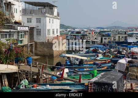 Crowded fishing village in Hong Kong HK. Lots of small craft fill the busy fishing port in a village in the new territories. Stock Photo