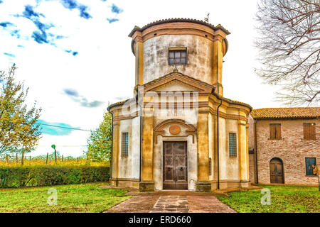 Facade of a XVIII century oratory, baroque church dedicated to an image of the Madonna from Loreto in the village of Passogatto near Ravenna in the countryside of Emilia Romagna in Northern Italy Stock Photo