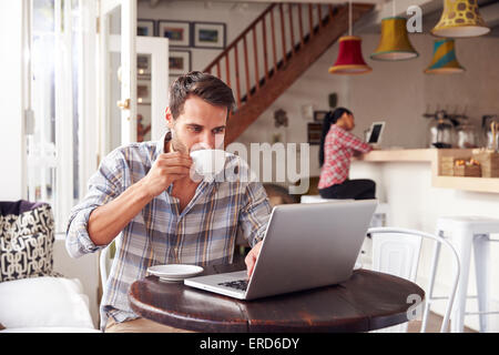 Young man using laptop in a cafe Stock Photo