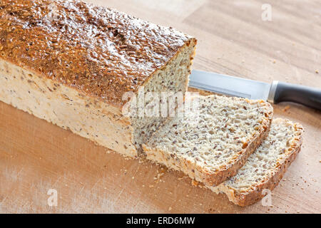 Fresh home made bread on a wooden bread board. Stock Photo