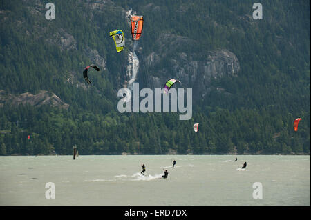 A kite boarder at the Squamish Spit kite boarding area.  Shannon Falls in the background.  Squamish BC, Canada. Stock Photo