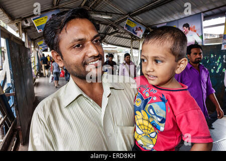 Mumbai India,Lower Parel Railway Station,Western Line,train,riders,passenger passengers rider riders,over bridge,man men male,father,male boy boys kid Stock Photo