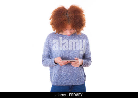 African American young woman sending a text message on her smartphone - Black teenager people Stock Photo