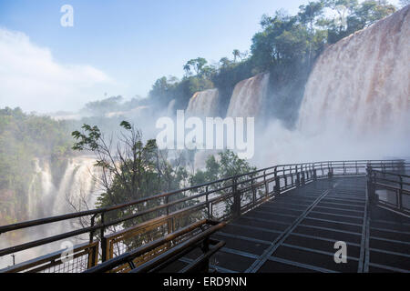 Walkway and viewing platform leading into the spray of the dramatic Iguazu Falls, taken from the Argentinian side Stock Photo