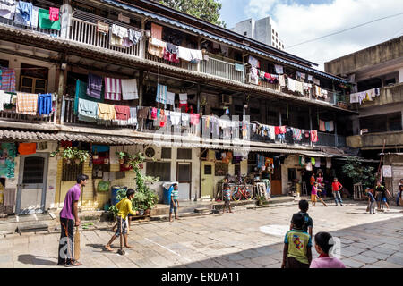 Mumbai India,Lower Parel,old condominium,residential,apartment,apartments,flat,building,hanging laundry,balconies,courtyard,male boy boys kids childre Stock Photo