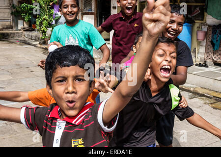 Mumbai India,Indian Asian,Lower Parel,courtyard,male boy boys lad lads kid kids child children,friends,playing,Hari Baug Box Cricket League,inner city Stock Photo