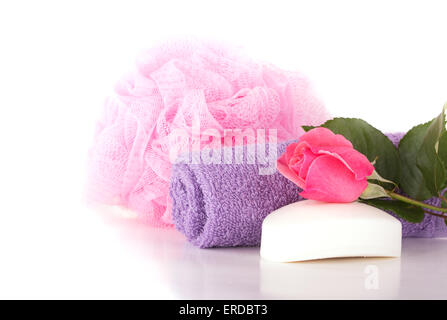 Wash cloth, shower puff, soap and pink rose on light background Stock Photo