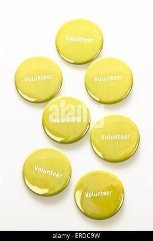 Several green volunteer buttons on white background Stock Photo