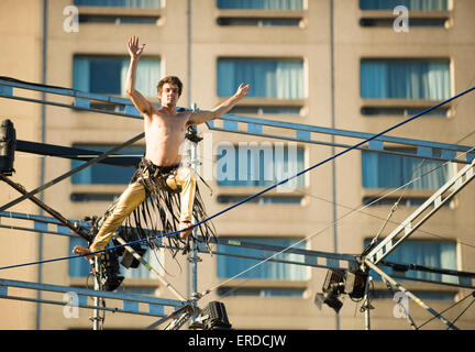 Family Fun in Montreal, Quebec, Canada. Completement Cirque Festival. Man walking on tight rope. Stock Photo