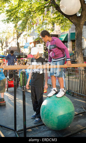 Family Fun in Montreal, Quebec, Canada. Completement Cirque Festival. Boy standing on ball. Stock Photo