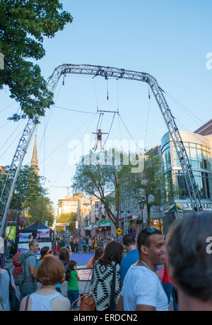 Family Fun in Montreal, Quebec, Canada. Completement Cirque Festival. Girl high up in the sky. Stock Photo