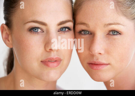 Portrait of two happy young women on square at sunset Stock Photo - Alamy