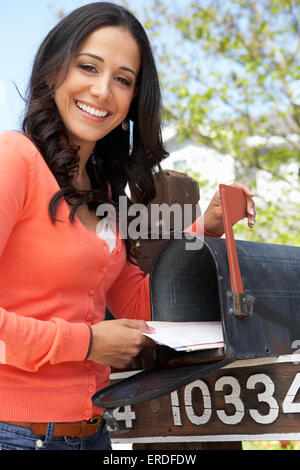 Hispanic Woman Checking Mailbox Stock Photo