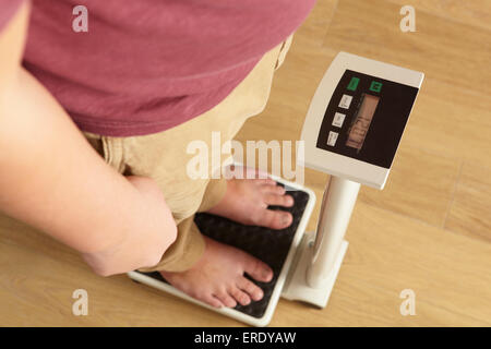 Man standing on digital scales cropped waist down Stock Photo