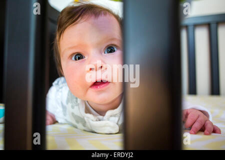 Close up of Caucasian baby girl laying in crib