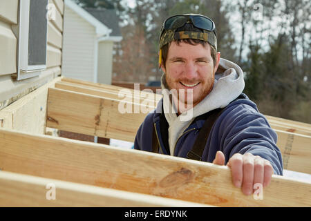 Caucasian carpenter building house extension in winter Stock Photo