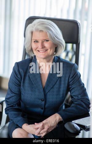 Caucasian businesswoman smiling at desk Stock Photo