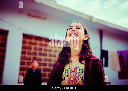 Girl looking up and laughing Stock Photo