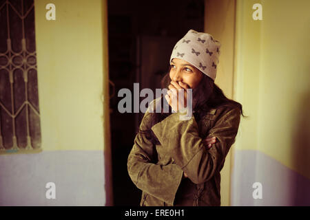 Laughing woman covering her mouth Stock Photo