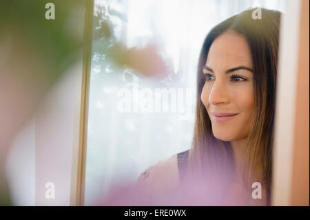 Caucasian woman admiring herself in mirror Stock Photo