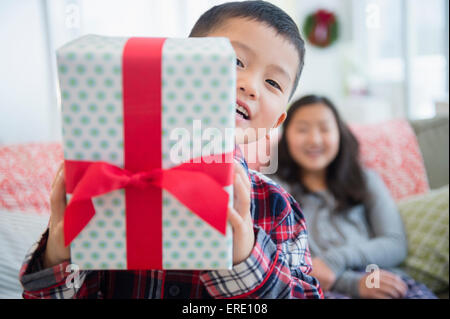 Asian brother with sister holding Christmas gift Stock Photo