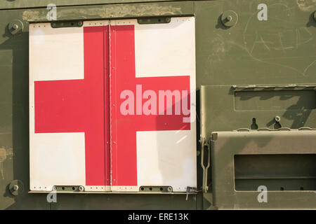 Military red cross symbol attached to an army vehicle serving as a mobile medical aid unit Stock Photo