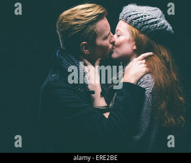 Couple wearing warm clothing kissing Stock Photo