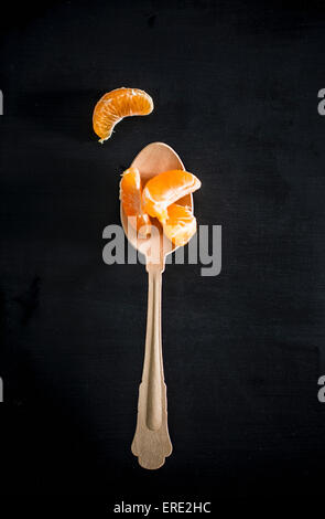 Spoon with orange slices Stock Photo