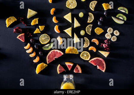 Sliced fruit arranged above juice bottle Stock Photo