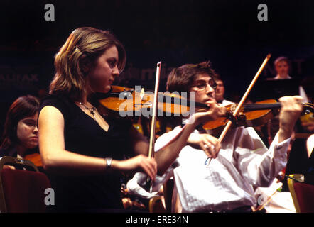 Violinists. Part of the violin section of a youth symphony orchestra, playing at the Royal Albert Hall, London as part of the Stock Photo