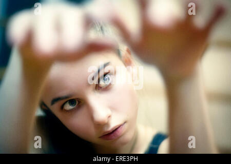 Caucasian girl examining her hands Stock Photo