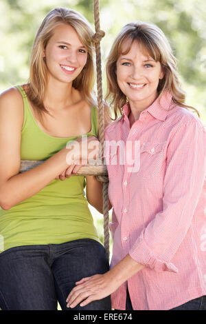 Mother And Teenage Daughter By Treehouse Stock Photo
