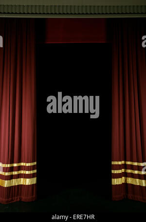 Red stage curtains with gold stripes, partly open Stock Photo