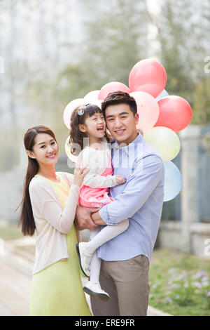 Happy young family with balloons