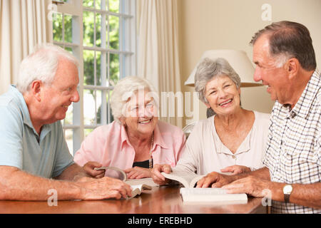 Group Of Senior Couples Attending Book Reading Group Stock Photo