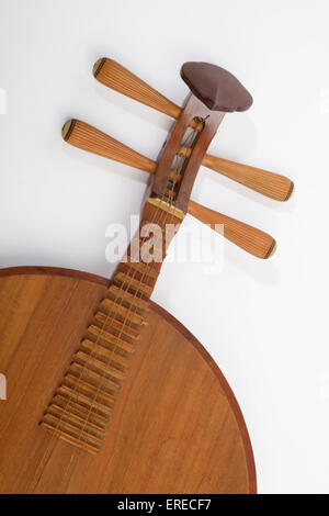 Chinese Moon shaped lute, or moon guitar. Yueh chin. Yueqin. Detail of scroll strings and tuning pegs. Stock Photo