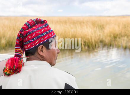 Local boatman wearing traditional brightly coloured knitted cap with tassel, Taquile Island, Lake Titicaca, Puno region, Peru Stock Photo