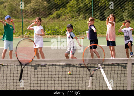 Kids playing tennis games at a charity tennis event, Headley, Hampshire, UK. Stock Photo