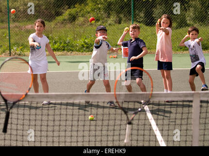 Kids playing tennis games at a charity tennis event, Headley, Hampshire, UK. Stock Photo