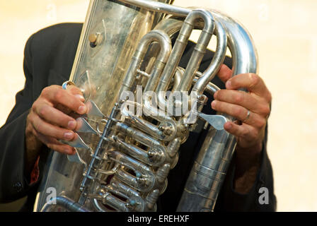 Close-up of bass tuba player's hands on valves. Stock Photo