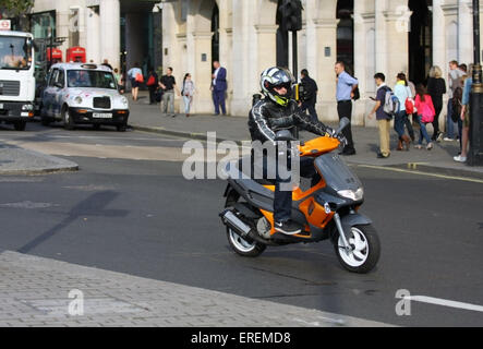 A motorcyclist traveling along The Strand towards Trafalgar Square, London, England Stock Photo
