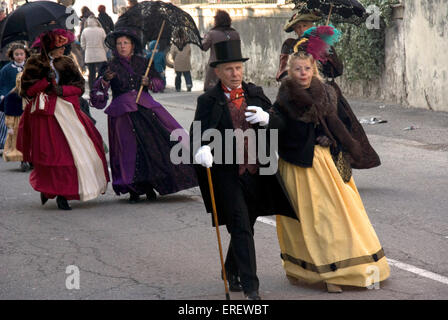 People in Victorian costumes taking part in a Valentine's Day parade in the village of Roquemaure, Southern France. Stock Photo