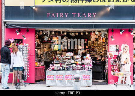 America Murai shopping district in Osaka. 'Fairy Teary' boutique for accessories for women with a young couple outside looking at rack of sunglasses. Stock Photo