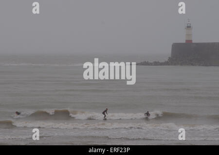 Newhaven, East Sussex, UK. 2nd June, 2015. Weather: Surfers at the West Arm Beach. A very windy day with mist and rain on the South Coast Stock Photo