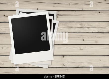 Polaroid photo frames on wooden background Stock Photo
