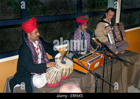 Rajasthani tabla and harmonium players, together with a Western accordionist. The musicians are Rafik Mohamed (left) and Barkat Stock Photo