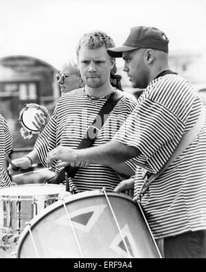 Drummers in Samba band, tambourine in the background. Stock Photo